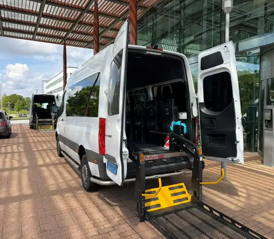 Professionele rolstoeltaxi chauffeur helpt klant in Almere